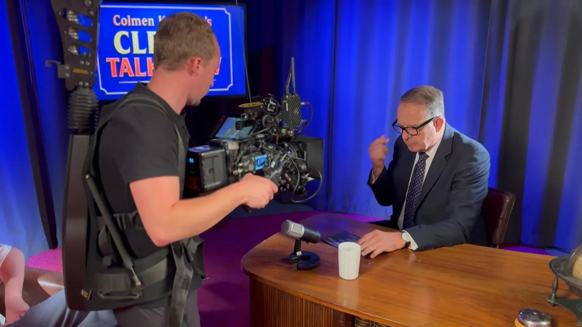 Theater – Talkshow-Produktion im Theater mit Steadicam-Operator, Moderator am Pult und blauer Studio-Kulisse